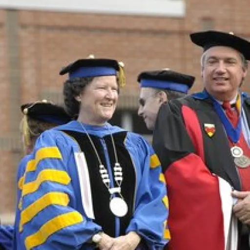 Woman in ceremonial academic cap and gown.