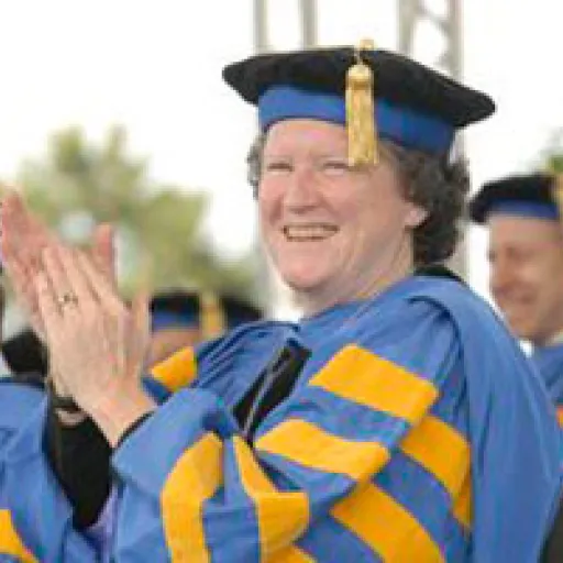 Woman in ceremonial academic cap and gown.