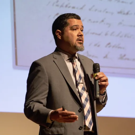 Male Professor Bradwell speaking with a mic