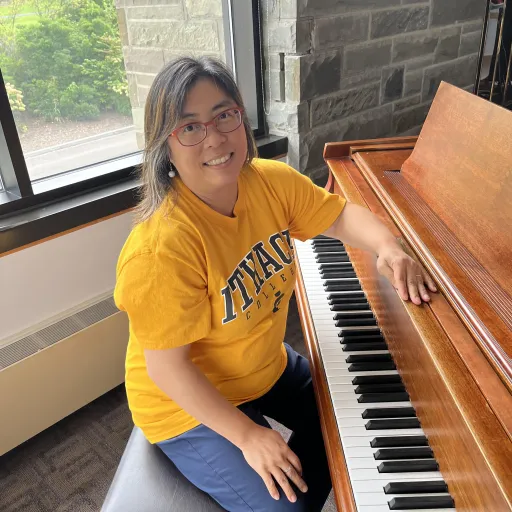 Photo of Melody sitting at a piano