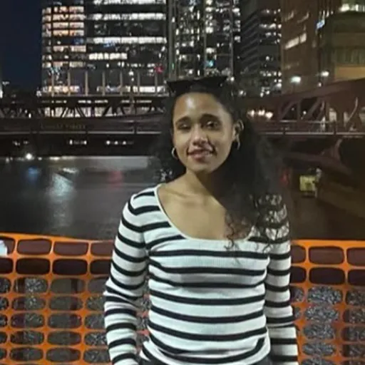 A woman standing in front of a cityscape