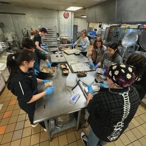 Students volunteer to pack meals for the Friendship Donations Network