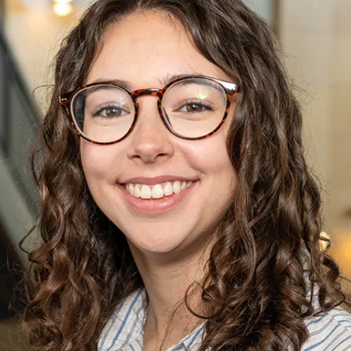Woman with glasses in a building atrium
