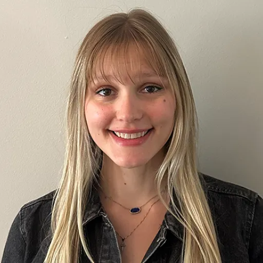 Photo of a woman in front of plain background