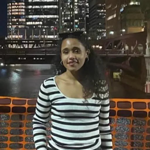 A woman standing in front of a cityscape