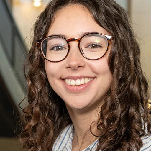 Woman with glasses in a building atrium